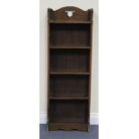 A George V Arts and Crafts style oak open bookcase, fitted with five shelves, on a plinth base,