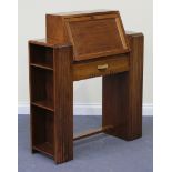 An Art Deco walnut student's bureau, with a fall flap and architectural style end supports, height