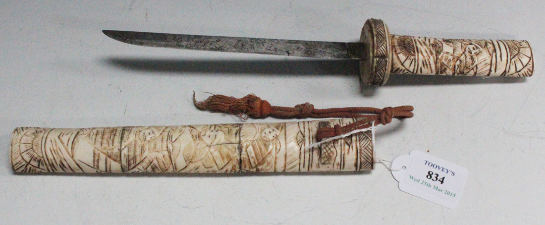 A Japanese carved bone tanto dagger with narrow single edged blade, length approx 18cm, grip