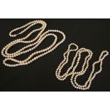 Two long single row necklaces of freshwater cultured pearls.