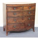 A George IV mahogany bowfront chest of two short and three long drawers with crossbanded borders, on