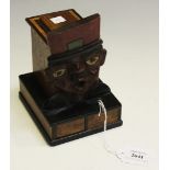An early 20th Century Continental softwood novelty cigarette dispenser in the form of a gentleman'