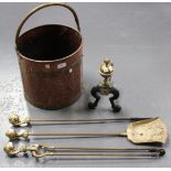 A late 19th Century copper and brass mounted coal bucket, a set of three brass fire tools and a cast