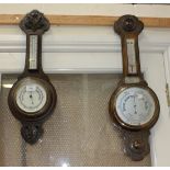 An early 20th Century oak wheel barometer with mercury thermometer and white glass dials, the case