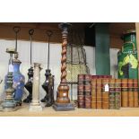 A group of various metalwork items, including a cloisonné table lamp, three cast metal doorstops,