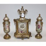 A late 19th Century French ormolu and silvered porcelain mantel clock garniture, the clock with