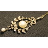 A rose diamond and cultured pearl set pendant in an oval wreath shaped design, with a ribbon bow and