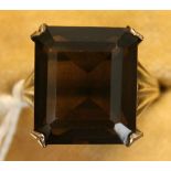 A 9ct gold ring, claw set with a cut cornered rectangular cut smoky quartz.