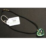 A Baccarat green glass heart shaped pendant with an 18ct gold suspension loop, length approx 3cm, on