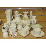 A collection of Belleek porcelain, including a model of a pig, a snowman bell Christmas tree