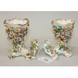 A pair of Coalbrookdale type porcelain cornucopia vases, circa 1840, each typically encrusted with