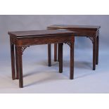 A pair of George III mahogany card tables, the rectangular fold-over tops above blind fret decorated