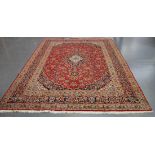 A Kashan carpet, Central Persia, late 20th Century, the claret field with a lobed foliate medallion,