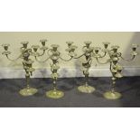 A set of four modern reproduction plated five light candelabra, raised on oval bases, height