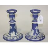 A pair of Wedgwood blue dip jasperware candlesticks, 19th Century, each flared stem ornamented in