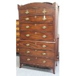 A late George III mahogany chest-on-chest, the shaped pediment above two short and six long drawers,