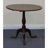 An early 19th Century oak circular tip-top wine table, on a turned column and tripod cabriole