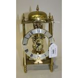 A modern gilt brass skeleton mantel clock, the silvered chapter ring with Roman numerals and