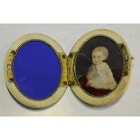 A late 19th Century ivory twin folding miniature travelling portrait frame with gilt metal fittings,