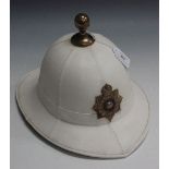 A post-1952 Royal Marines tropical helmet, dated 1975, with earlier helmet plate, retaining ball top