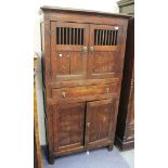 A late George III provincial oak food cupboard, fitted with a pair of panelled doors with slatted