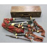 An early 20th Century blackwood and ivory mounted set of bagpipes, with mahogany box, and another