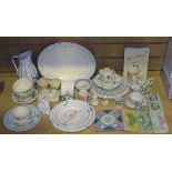 A collection of Susie Cooper tableware, including a three piece condiment set and stand decorated