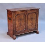 A mid-Victorian walnut portfolio cabinet, the rectangular moulded top above panelled hinge fall flap