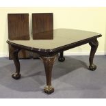 A modern Victorian style mahogany extending dining table, the moulded top fitted with two extra