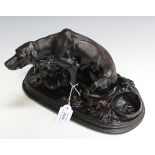 After P.J. Mene - a 20th Century cast iron figure group of a dog and her puppies, on an oval base,