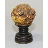 A Chinese carved ivory and turned wooden desk seal, early 20th Century, the ivory ball surmount