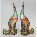 A pair of Chinese porcelain figures of phoenix, 20th Century, each modelled standing with green,