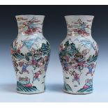 A pair of Chinese famille rose porcelain vases, mid-19th Century, each painted with scenes of