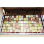 A Victorian and later stained and painted glass rectangular panel, the five painted roundels