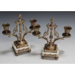 A pair of late 19th/early 20th Century French gilt metal and white marble twin branch candelabra,