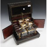 A mid-19th Century French ebonized and brass line inlaid decanter box, the hinged lid and sides