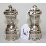 A pair of silver pepper mills, London 1979, height approx 10.5cm.