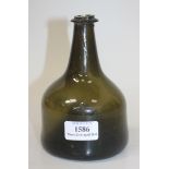 An olive green tinted glass wine bottle, mid-18th Century, of mallet shape with string rim and