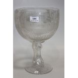 An oversize engraved glass wine goblet, dated 1870, the rounded bowl engraved with a titled view