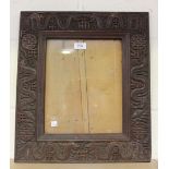 An early 20th Century Singaporean hardwood frame, carved in relief with a border of dragons,