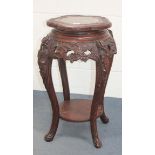 A Chinese carved softwood jardinière stand, early 20th Century, the lobed top inset with a grey