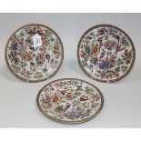 A set of three Chinese 'clobbered' blue and white export porcelain plates, Qianlong period, each