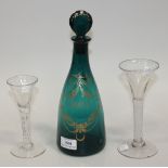 A green glass decanter and stopper, early 19th Century, of mallet shape, gilt with a foliate