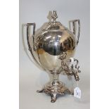 A late 19th Century plated samovar, the ovoid body with angular handles, raised on a circular base