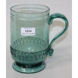 A green glass tankard, late 18th/19th Century, the cylindrical body above a band of moulded