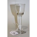 A double series opaque twist stem wine glass, circa 1770, the rounded funnel bowl raised on a