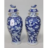 A pair of Chinese blue and white porcelain vases and covers, mark of Kangxi but late 19th Century,