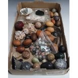 A collection of late 20th Century hardstone balls, various wooden eggs, a collection of shells and