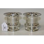 A pair of Edwardian silver urn shaped vases with reeded rims, London 1905 by William Comyns & Sons