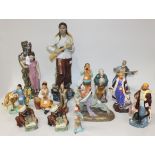 A collection of fourteen Chinese porcelain and pottery figures, Republic period and later, including